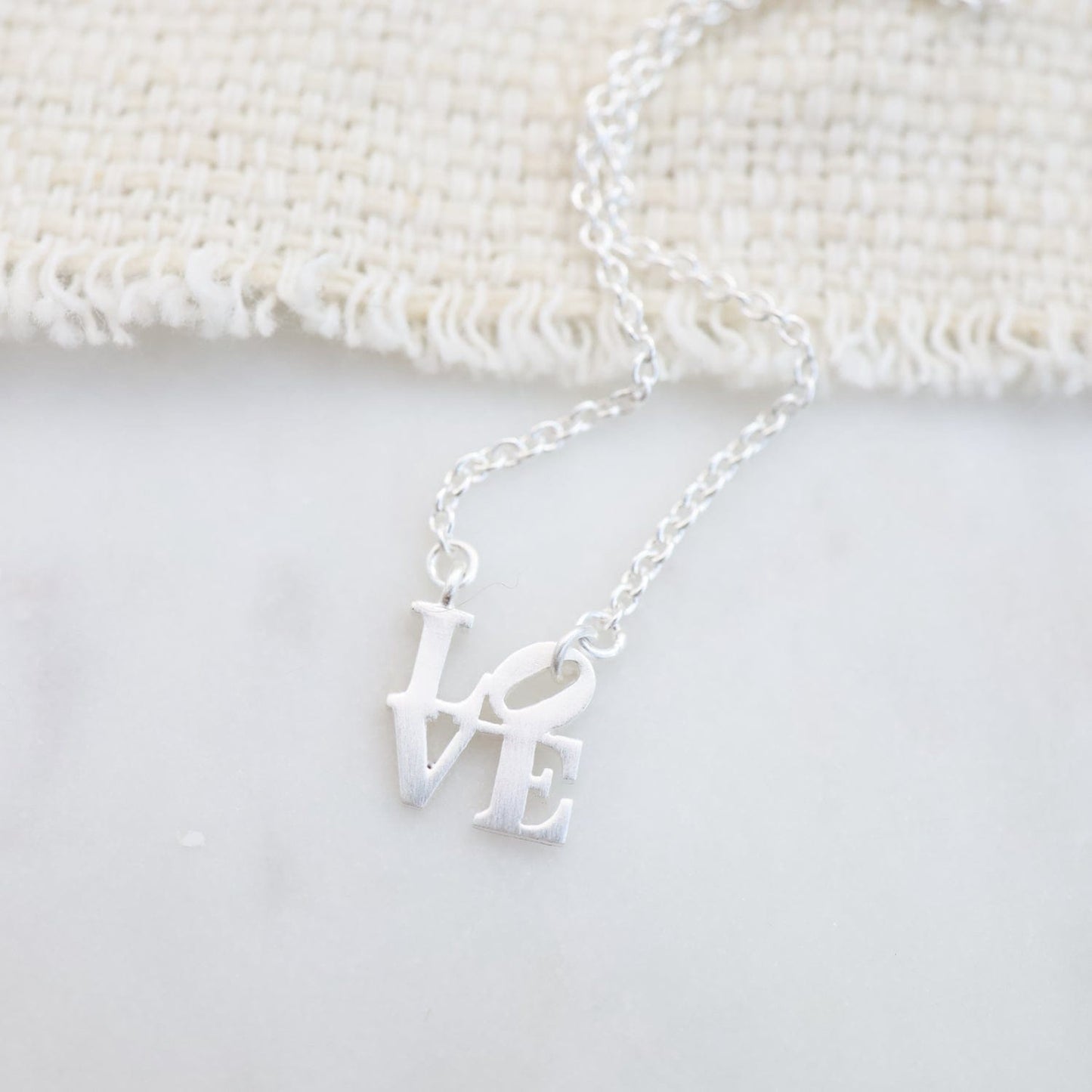 NKL Matte Silver Extra Petite LOVE Sculpture Necklace